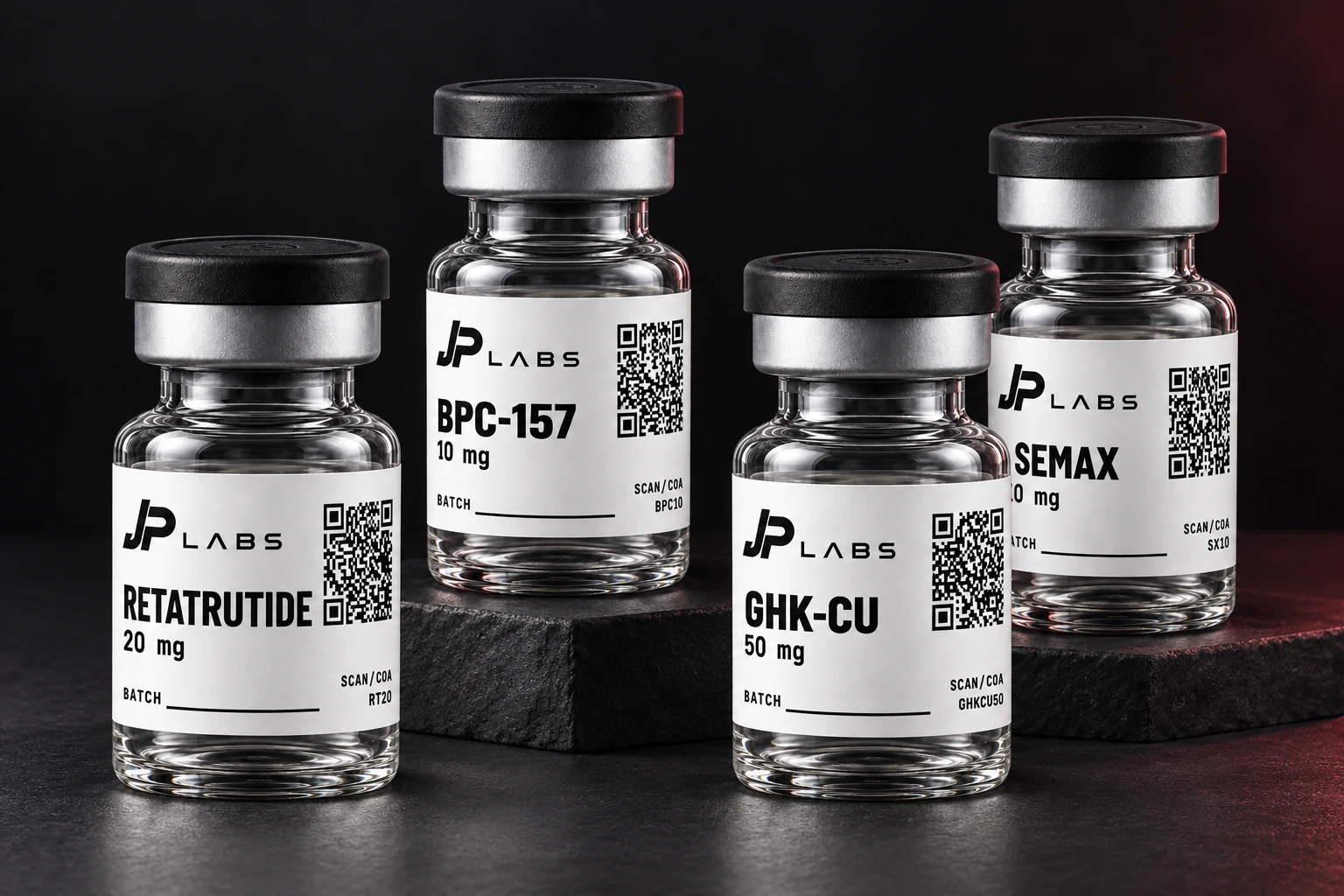 Illustrative JP Labs collection: Retatrutide, BPC-157, GHK-Cu and Semax vials in a dark studio setting